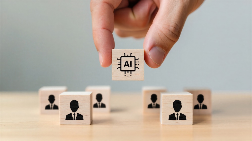 AIと書かれた木のブロックをつまむ手